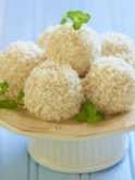 a white cake stand with 5 coconut bombs on top