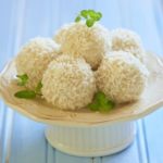 a white cake stand with 5 coconut bombs on top