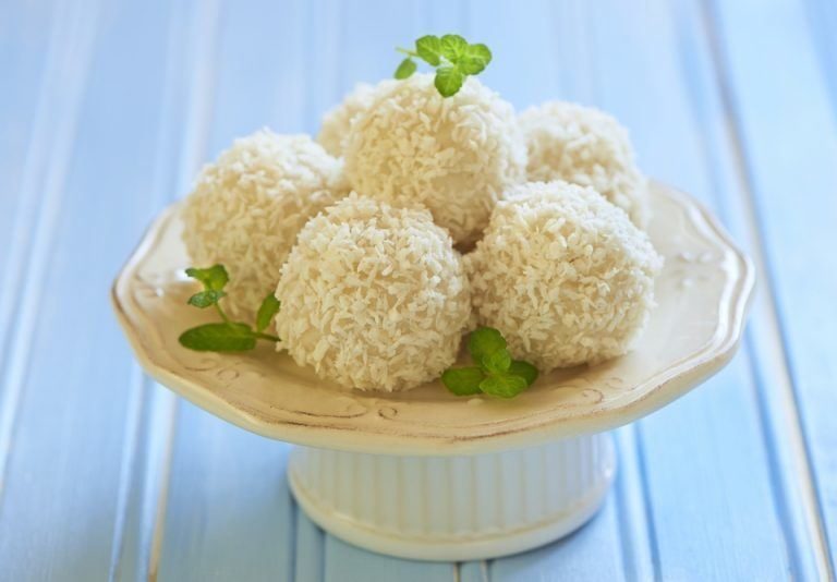 a white cake stand with 5 coconut bombs on top