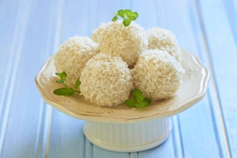 a white cake stand with 5 coconut bombs on top