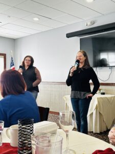 Crissy and her associate giving a speech at the DGUNH meeting