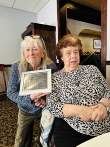 Carol and Julie showing the Janet Akins award given to Marie Johnson